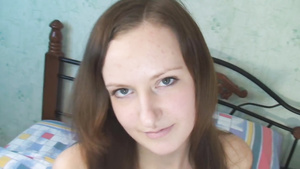 Flirty dark haired girl rubs her pussy slit in bed