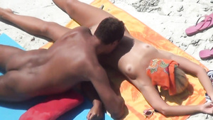 Spying for couple of nudists chilling on the beach