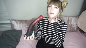 Playful camwhore sucks sex toys in solo action