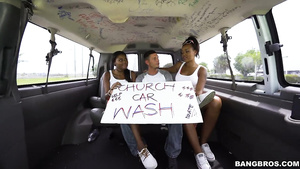 Ebony babes give lucky dude a double blowjob in a moving car