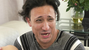 A cuckold with caged cock watches another man fucking his wife